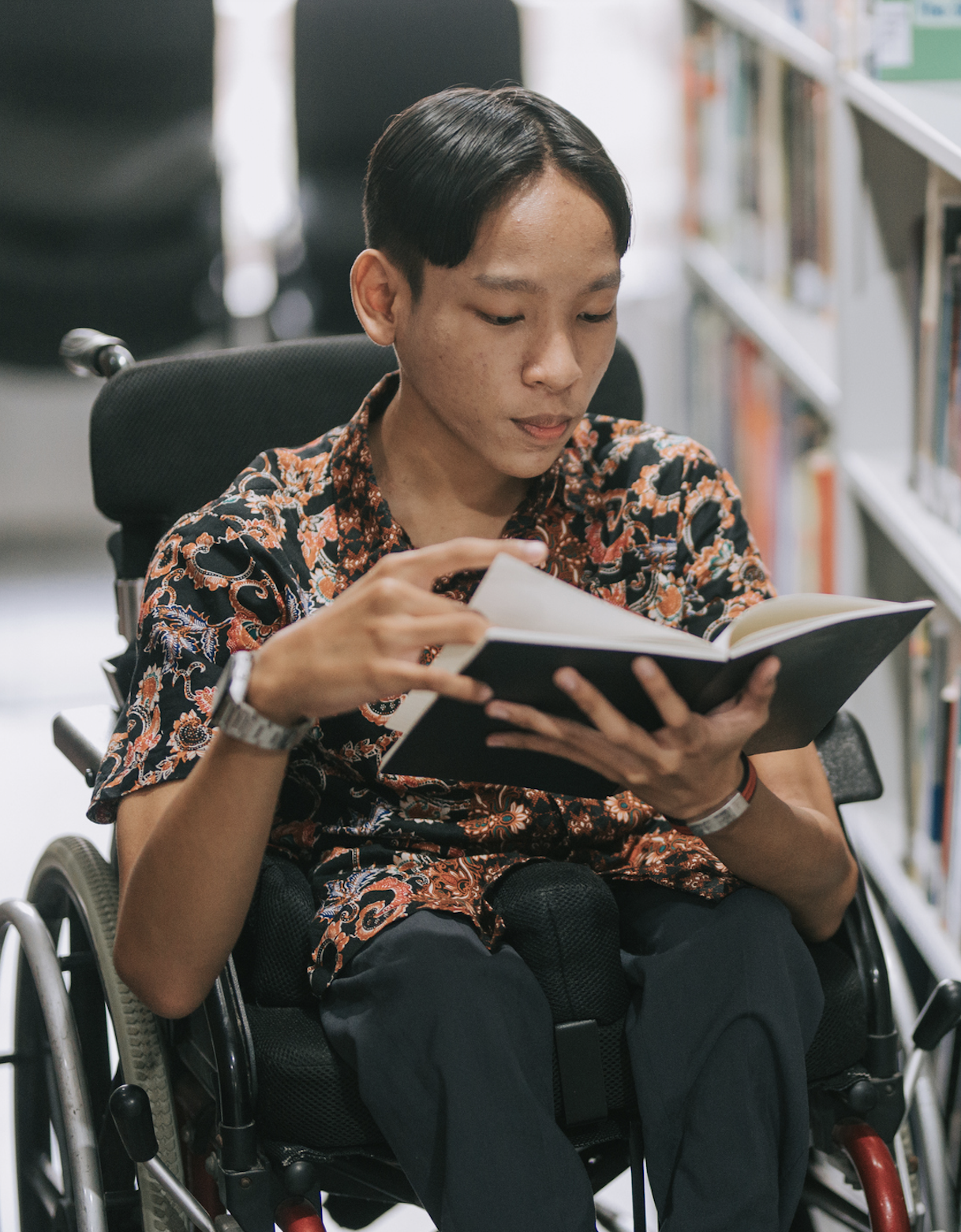 boy in wheelchair reading