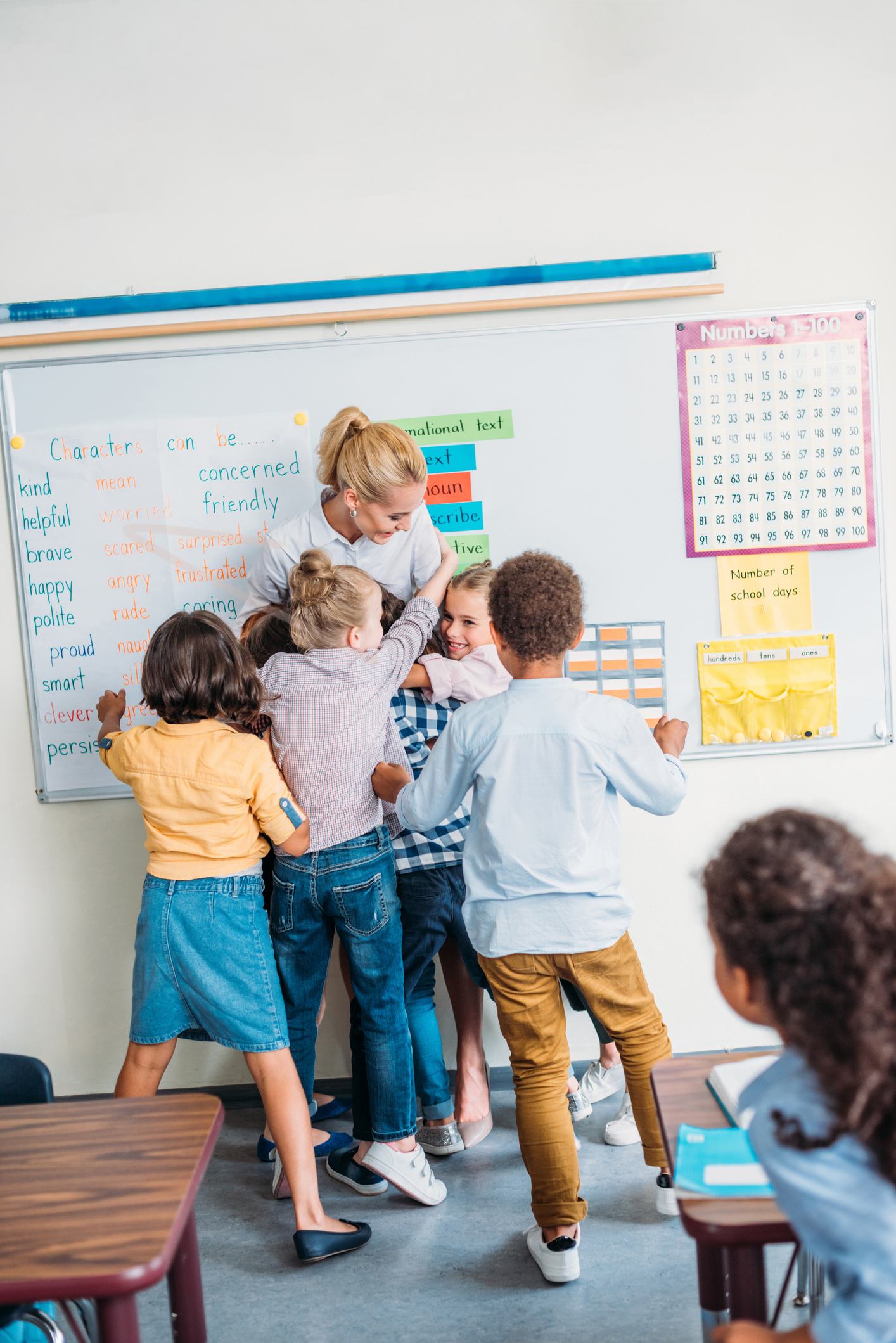 students hug teacher