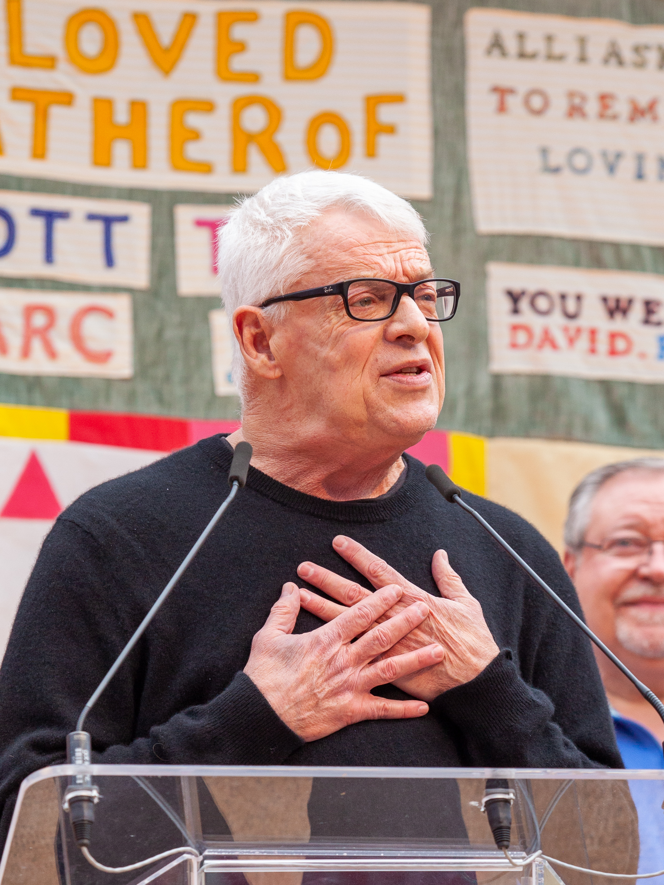Cleve Jones holding a panel from the AIDS Memorial Quilt; LGBTQ and labor activist.