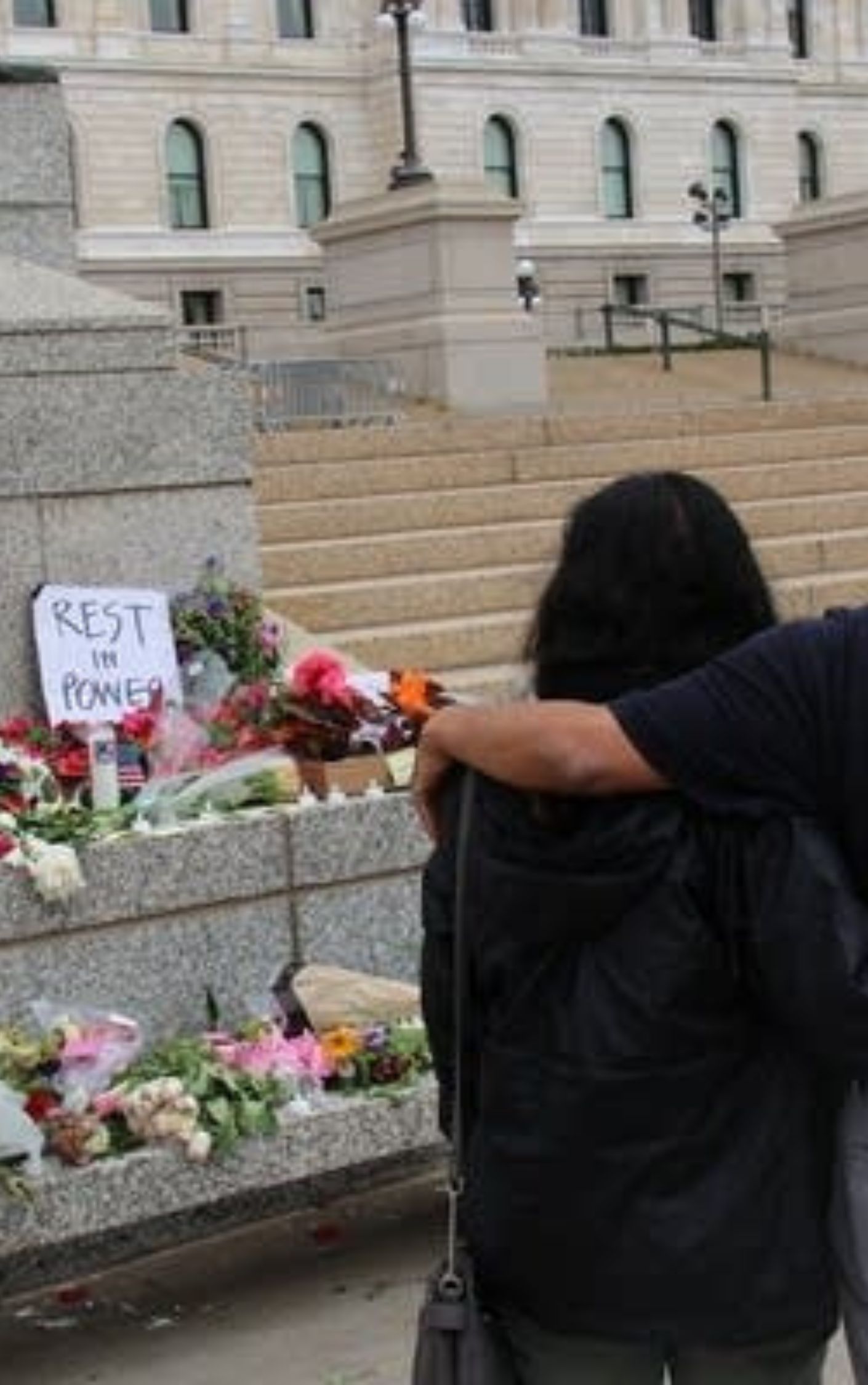 people mourn state senator hortman in front of the minnesota state capitol