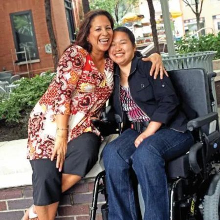 Paraprofessional Margaret Espinoza, left, with former student Becky Zang 10 years after 9/11, when the para wheeled and carried her student away from the World Trade Center. Credit: Bruce Gilbert