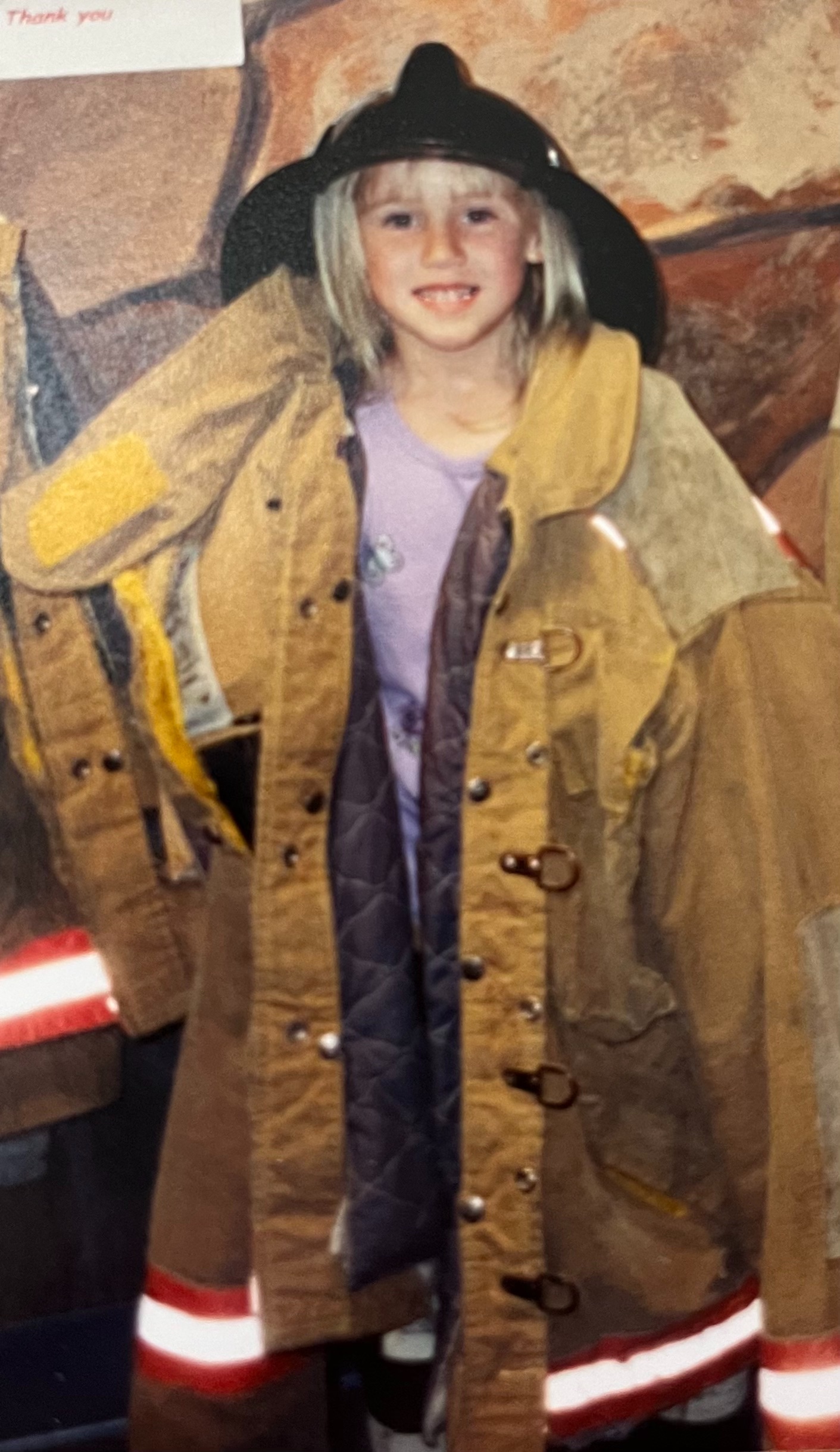 Megan Ortmeyer dressed in a firefighter jacket