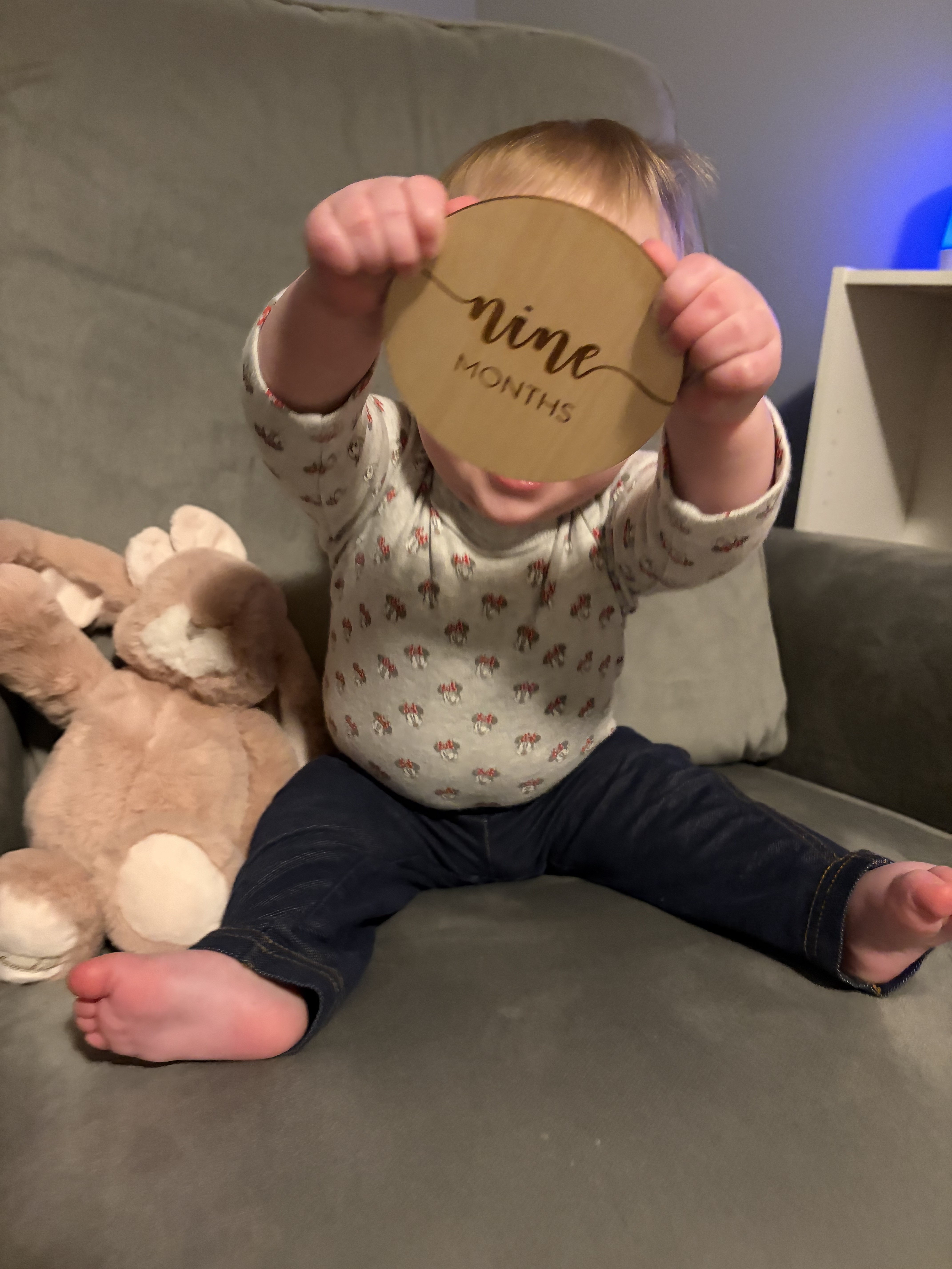 The author's daughter holds up nine months