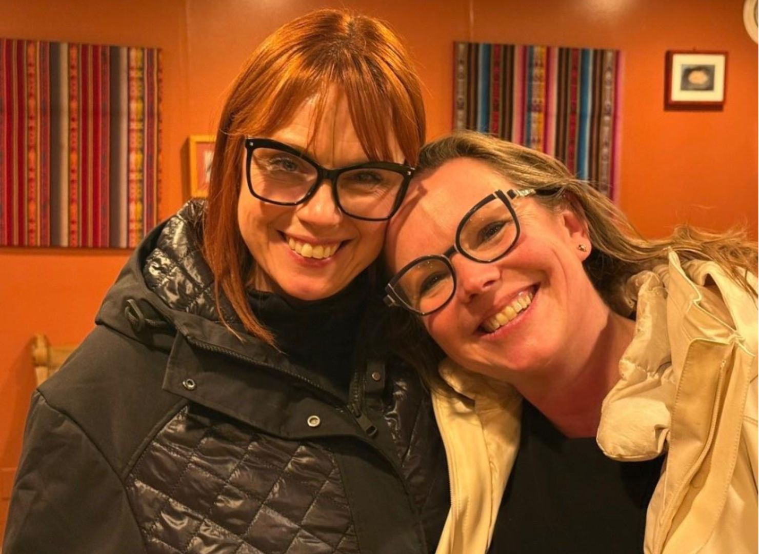 Kelly Booz and Emily smiling together indoors during a visit to Minnesota amid community organizing efforts.