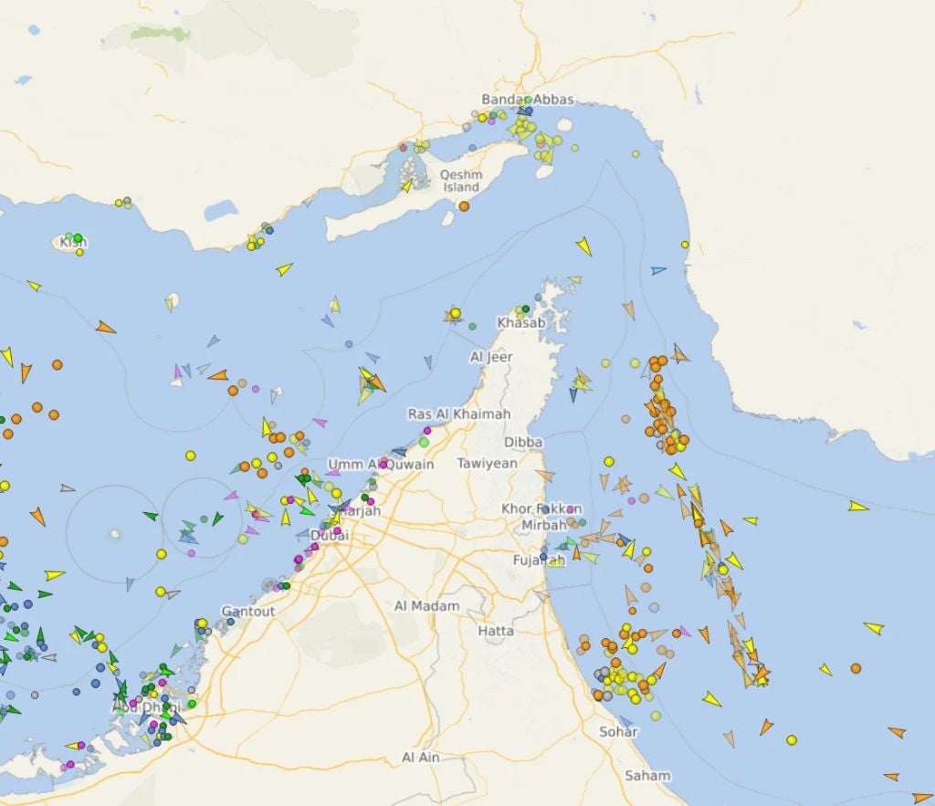 A vessel tracking map showing ship traffic in the Strait of Hormuz as of March 10, 2026, with dozens of vessels represented by colored markers and arrows near Iran, the UAE, and Oman.