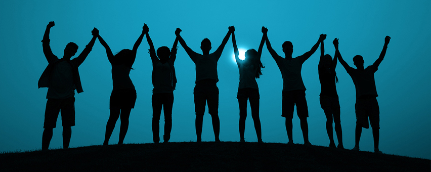 People holding hands with their arms raised